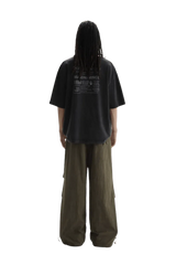 Back view of a person wearing Masonprince WashTag Tee black oversized t-shirt with printed wash tags