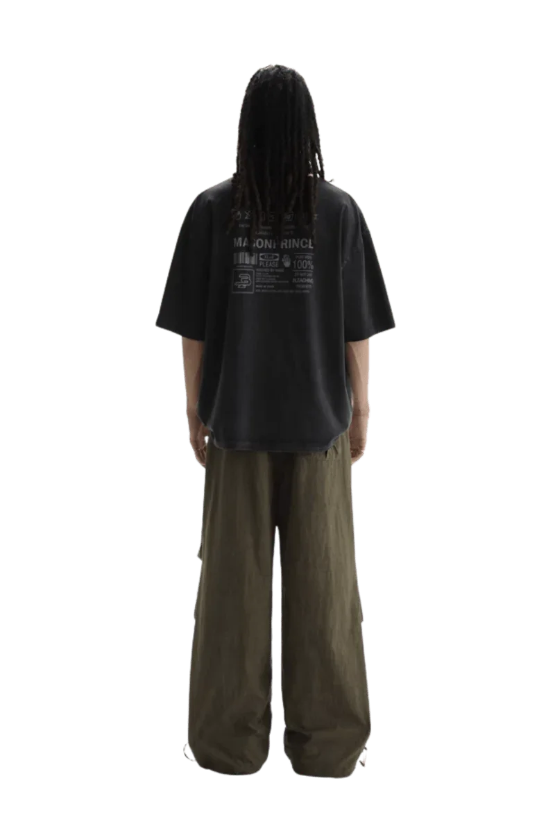 Back view of a person wearing Masonprince WashTag Tee black oversized t-shirt with printed wash tags