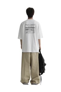 Back view of a person wearing Masonprince WashTag Tee white oversized shirt with printed care label design