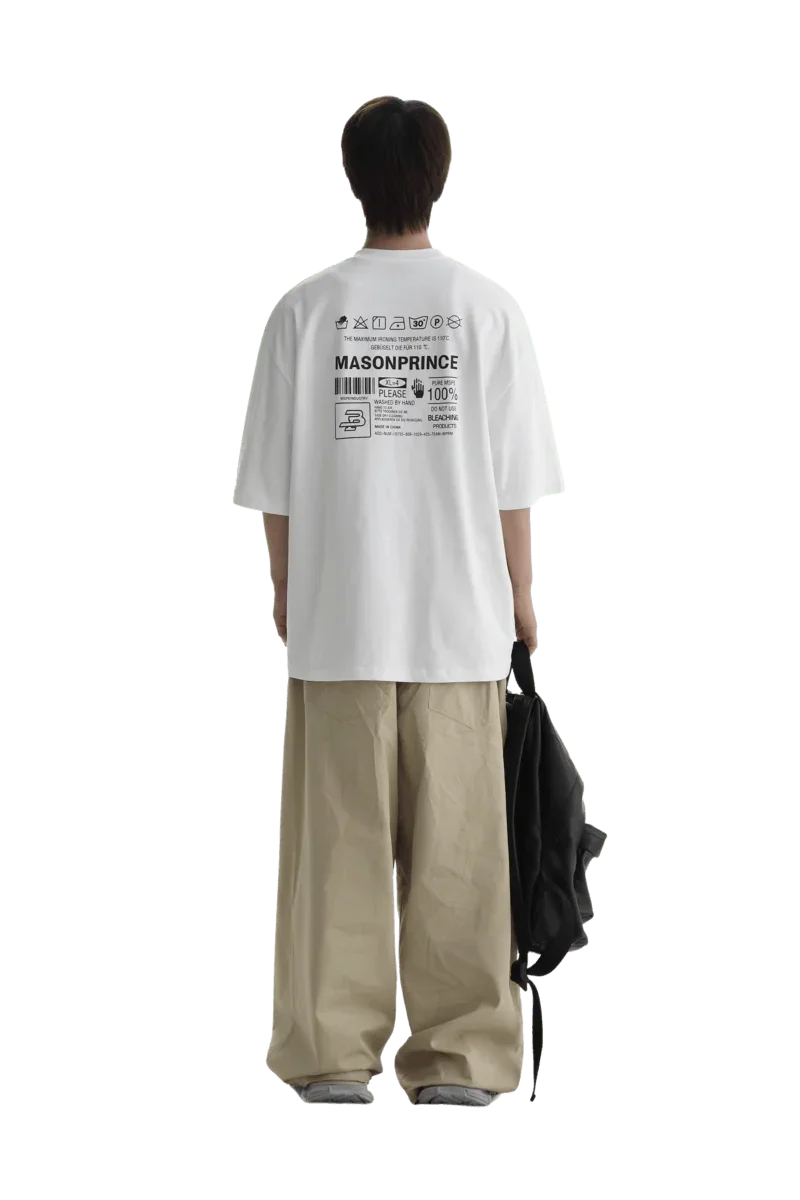 Back view of a person wearing Masonprince WashTag Tee white oversized shirt with printed care label design