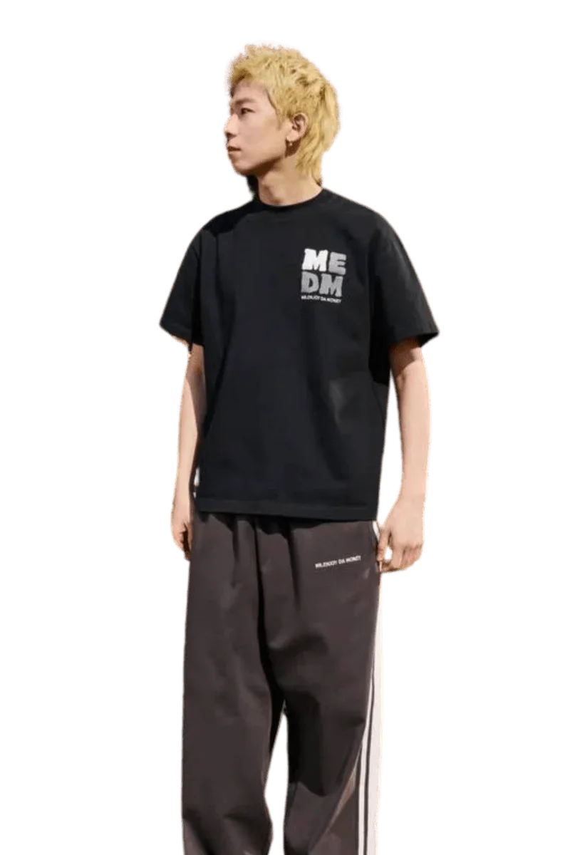 Black MEDM Badge Tee by Mr Enjoy Da Money worn with casual pants for a stylish look