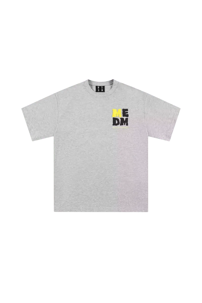 Gray MEDM Badge Tee featuring a bold logo design on the chest for casual style
