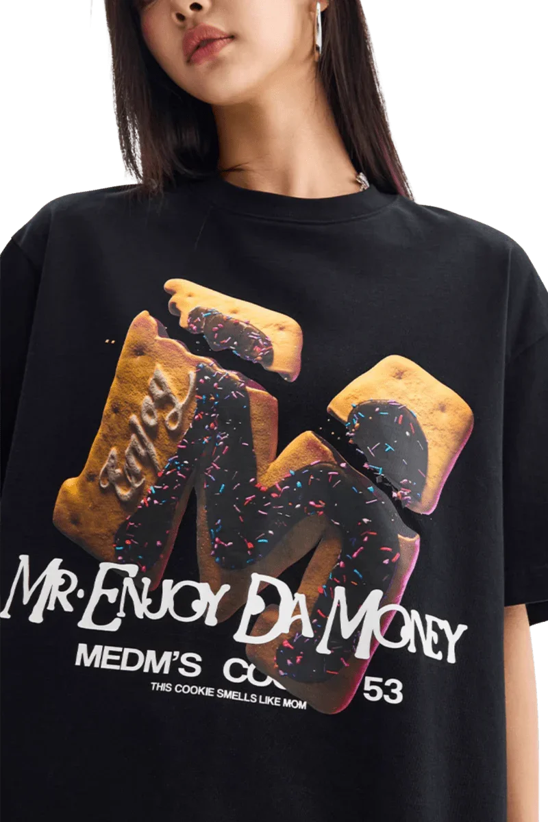 MEDM Big M Cookie Tee in black featuring colorful cookie graphic and bold text from Mr Enjoy Da Money