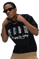 Man wearing black MEDM Burnt Laced Tee by Mr Enjoy Da Money with graphic text and stylish sunglasses