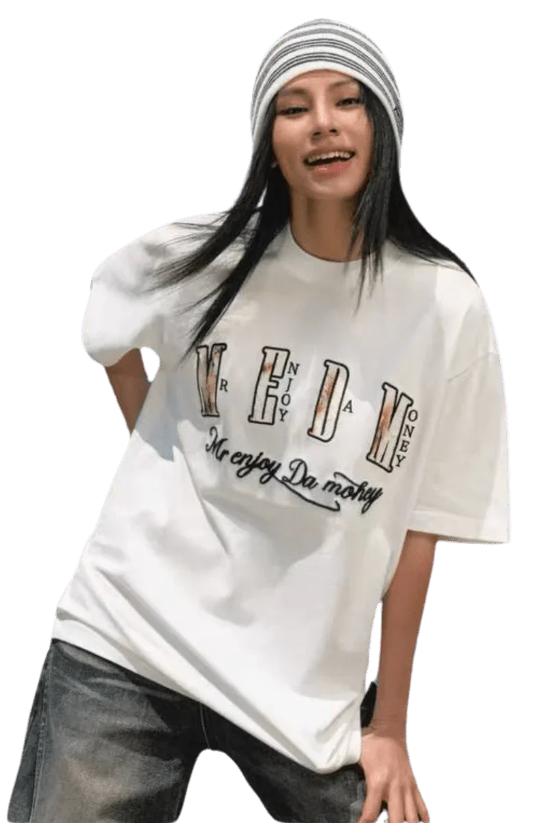 Young woman wearing a white MEDM Burnt Laced Tee by Mr Enjoy Da Money with black and white striped beanie
