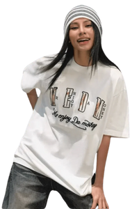 Young woman wearing a white MEDM Burnt Laced Tee by Mr Enjoy Da Money with black and white striped beanie