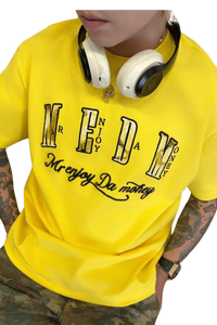Yellow MEDM Burnt Laced Tee by Mr Enjoy Da Money worn with headphones and camo pants