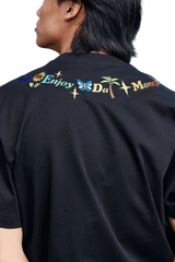 Back view of black MEDM Butterfly Necklace Embroidery Tee by Mr Enjoy Da Money with colorful embroidered text and symbols