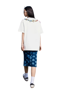 Woman wearing MEDM Butterfly Necklace Embroidery Tee white oversized shirt with colorful embroidered design on back