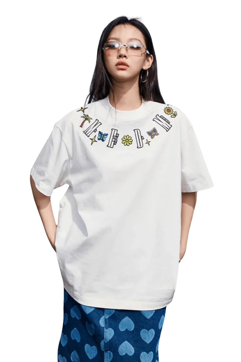 White MEDM Butterfly Necklace Embroidery Tee by Mr Enjoy Da Money worn with blue heart patterned pants