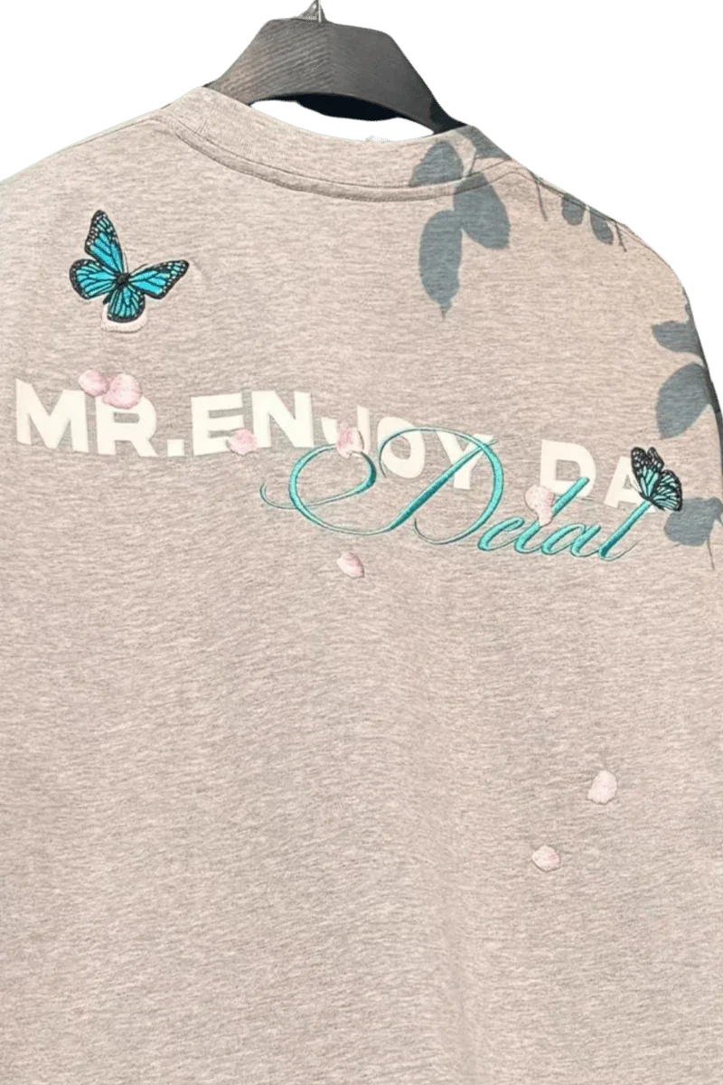 MEDM Falling Petals Embroidery Tee by Mr Enjoy Da Money with butterfly and petal embroidery on gray fabric