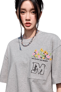 MEDM Flower Embroidery Pocket Tee in gray featuring vibrant floral design and relaxed fit
