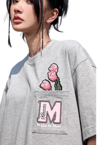 Gray MEDM Pixelated Flower Pocket Tee by Mr Enjoy Da Money featuring pixelated pink flowers and embroidered M logo on pocket