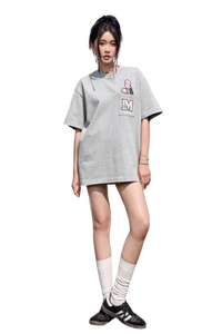 Model wearing a gray MEDM Pixelated Flower Pocket Tee by Mr Enjoy Da Money with pink flower graphic and letter M patch