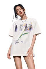Woman wearing white MEDM Smudged Floral Tee by Mr Enjoy Da Money with floral and text design