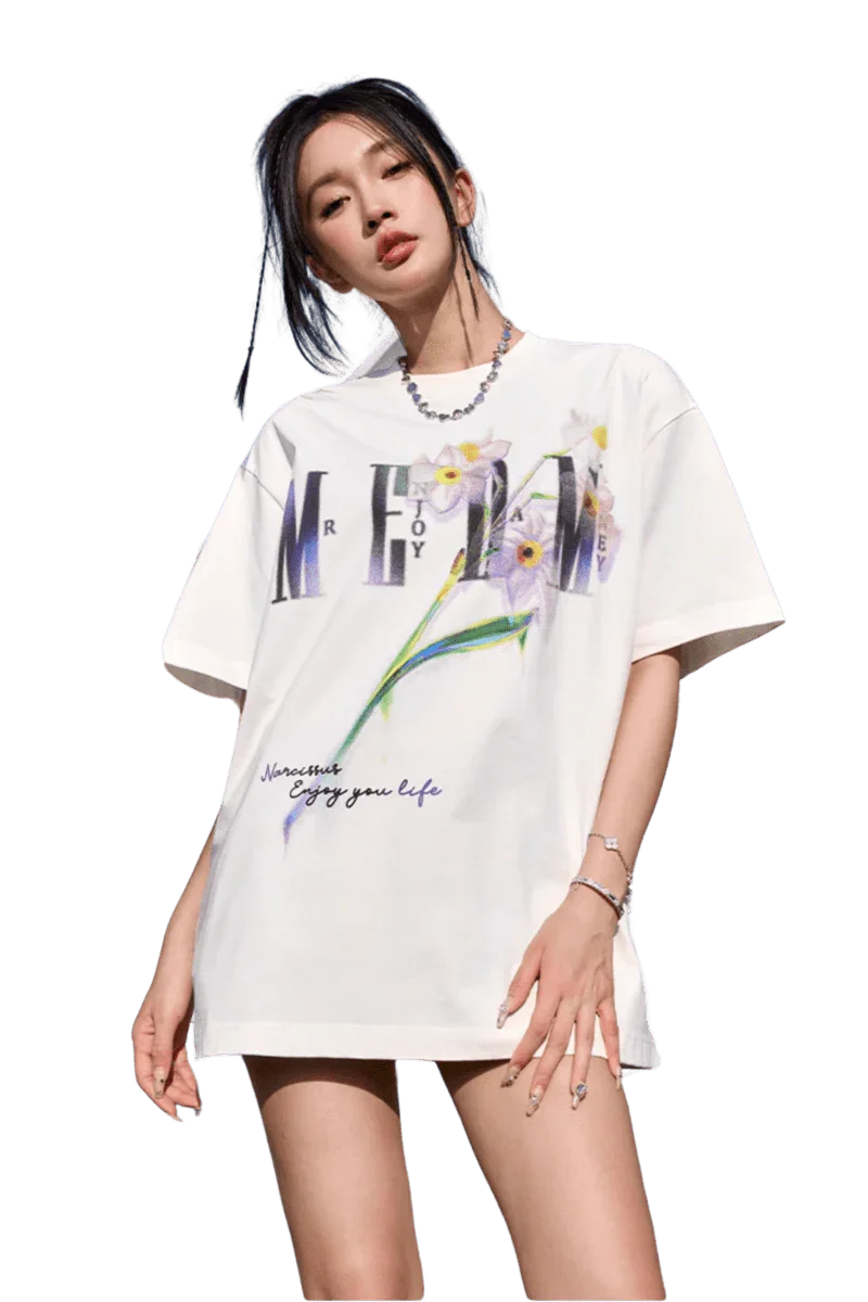 Woman wearing white MEDM Smudged Floral Tee by Mr Enjoy Da Money with floral and text design