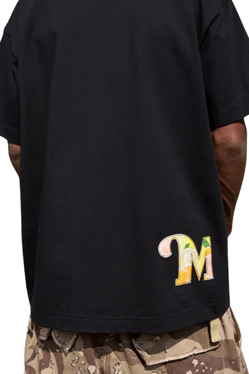 Black MEDM SS24 Flower Patch Embroidery Tee featuring a colorful embroidered logo on the back