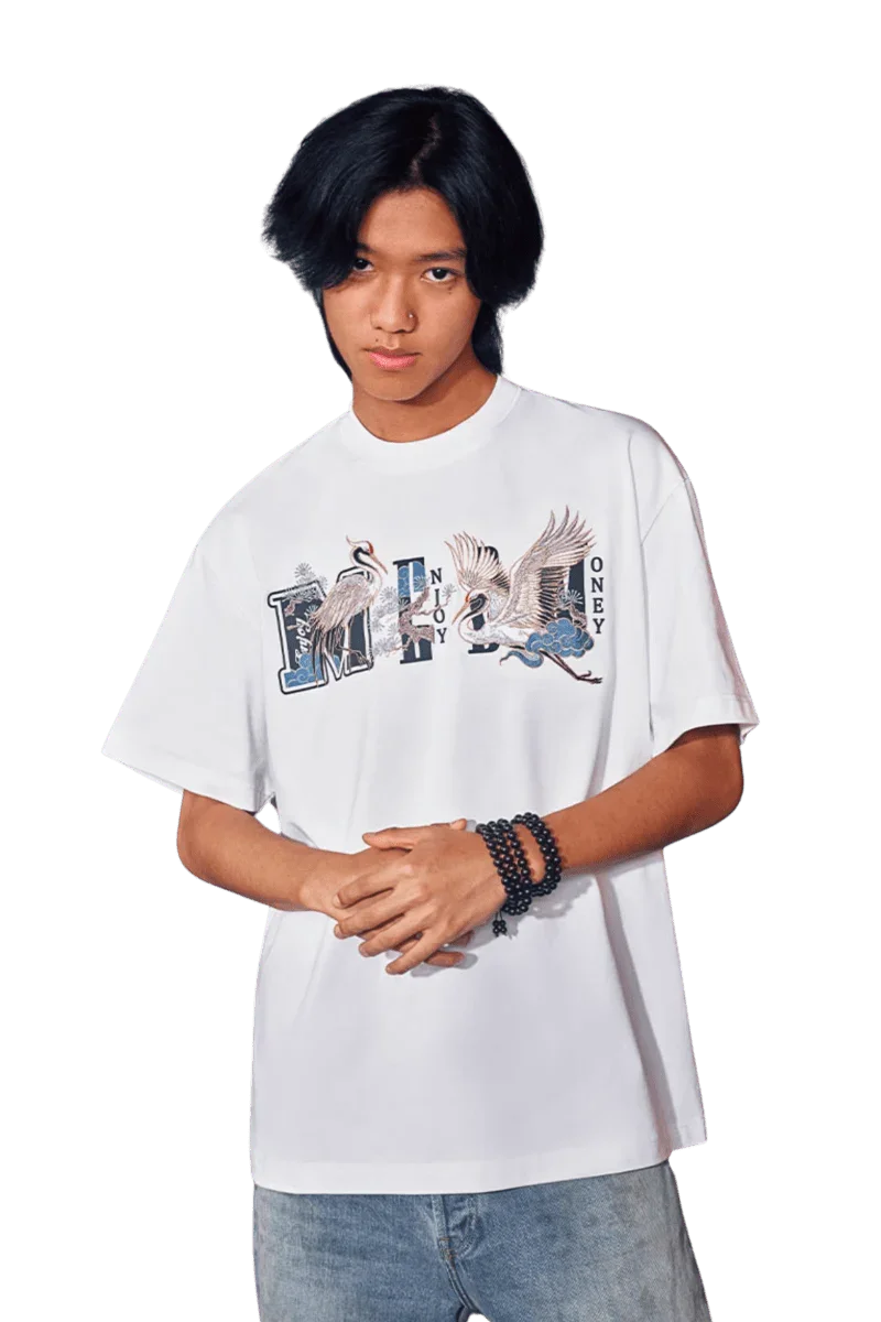 Model wearing MEDM SS24 Phoenix Embroidery Tee featuring detailed bird graphics and a relaxed fit
