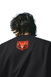 MEDM SS24 x Karmen Rider Tee featuring a bold logo print on the back of a black t-shirt
