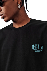 Close-up of MEDM SS25 Basic Embroidery Tee in black featuring Mr Enjoy Da Money logo on chest