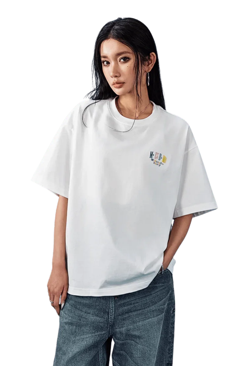 Model wearing MEDM SS25 Basic Embroidery Tee in white with loose fit and stylish design