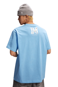 Stylish blue MEDM SS25 Basic Gem Series Tee featuring a unique logo design on the back