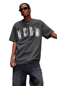 Street style model wearing MEDM SS25 Basic Gem Series Tee in gray with bold lettering for a trendy look