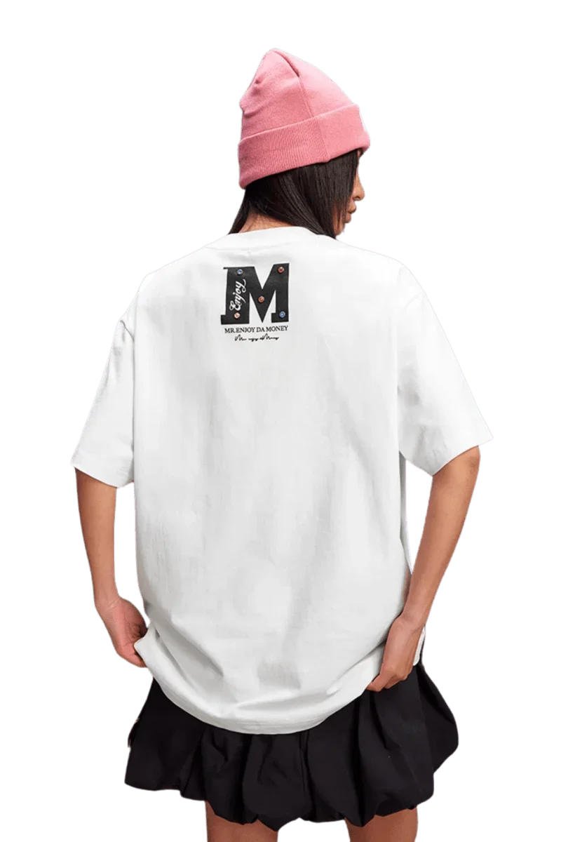 Model wearing MEDM SS25 Basic Gem Series Tee in white with a stylish back design and a pink beanie