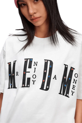 MEDM SS25 Basic Gem Series Tee featuring bold lettering and colorful embellishments on a white background