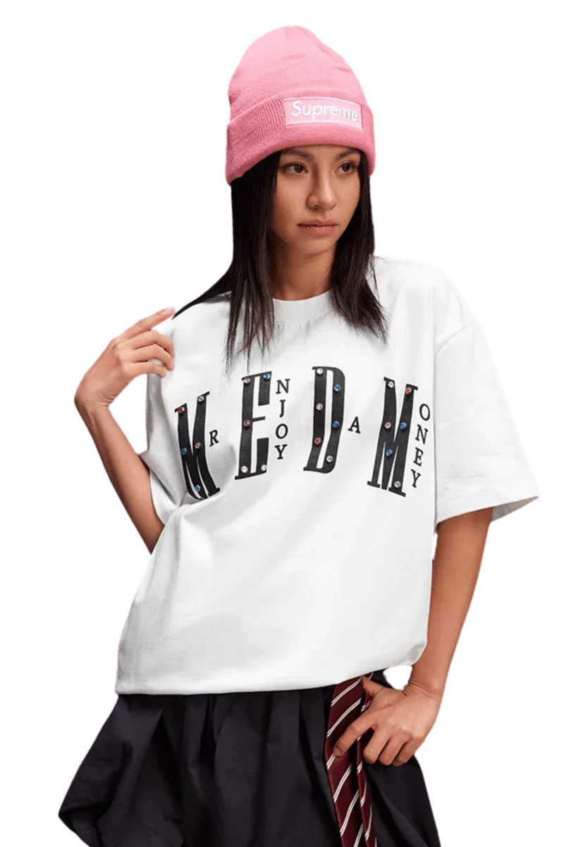 Model wearing a white MEDM SS25 Basic Gem Series Tee paired with a pink beanie and stylish skirt