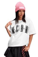 Model wearing a white MEDM SS25 Basic Gem Series Tee paired with a pink beanie and stylish skirt
