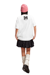 Girl wearing a white MEDM SS25 Basic Gem Series Tee with a stylish black skirt and pink beanie