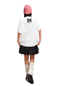 Girl wearing a white MEDM SS25 Basic Gem Series Tee with a stylish black skirt and pink beanie