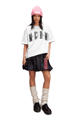 Stylish model wearing the MEDM SS25 Basic Gem Series Tee with a relaxed fit and black skirt