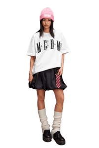 Stylish model wearing the MEDM SS25 Basic Gem Series Tee with a relaxed fit and black skirt