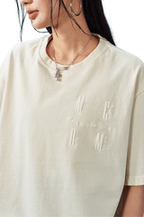 MEDM SS25 Basic Logo Washed Tee in cream color featuring embroidered logo detail on the chest