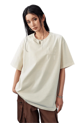Model wearing the MEDM SS25 Basic Logo Washed Tee in a soft cream color, perfect for casual outfits
