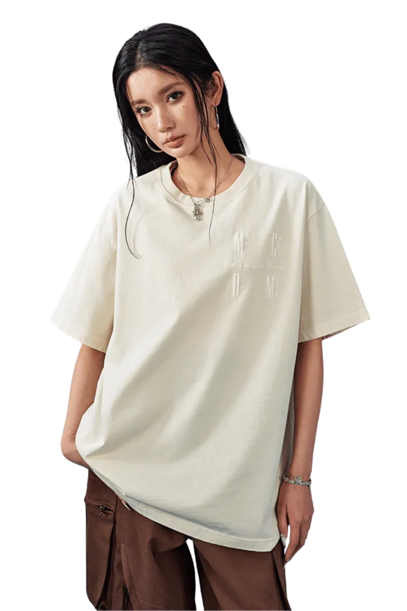 Model wearing the MEDM SS25 Basic Logo Washed Tee in a soft cream color, perfect for casual outfits
