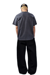 Back view of a gray MEDM SS25 Basic Logo Washed Tee styled with relaxed black pants