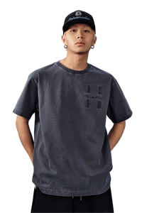 Model wearing MEDM SS25 Basic Logo Washed Tee in dark gray with a relaxed fit and unique design