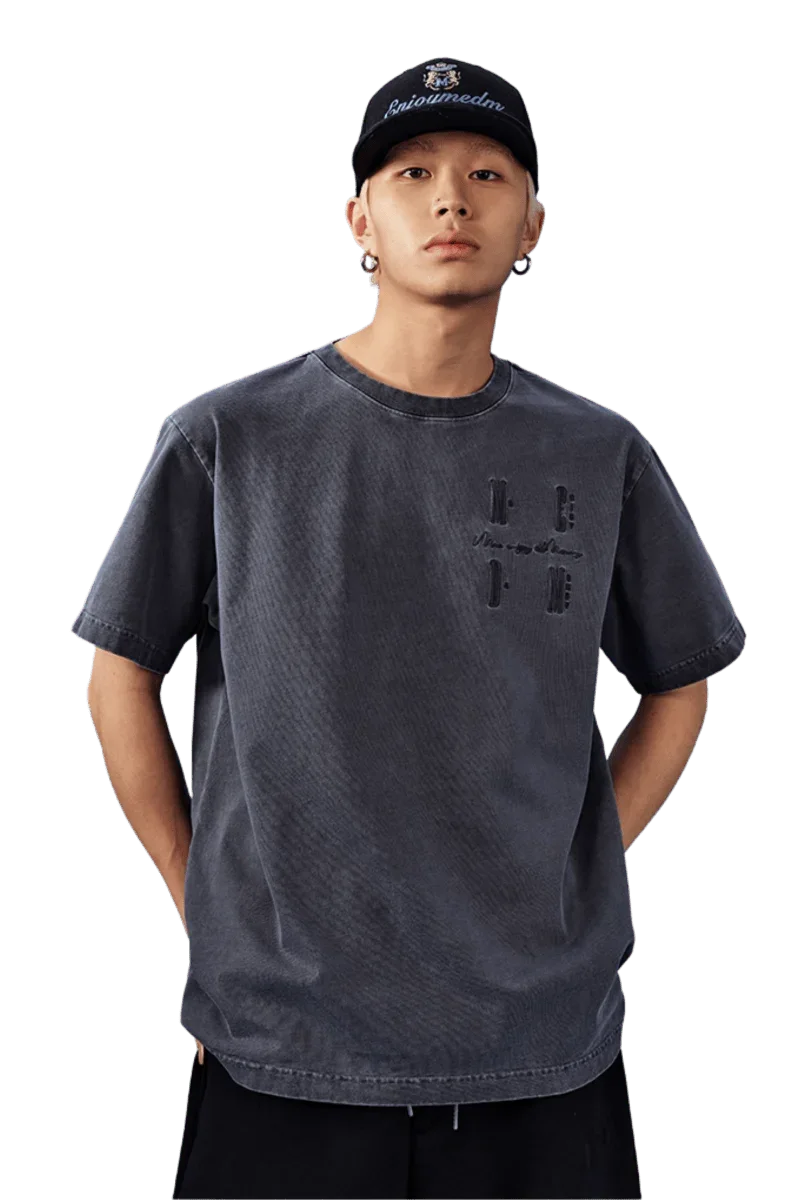 Model wearing MEDM SS25 Basic Logo Washed Tee in dark gray with a relaxed fit and unique design