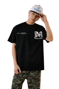 MEDM SS25 Big M Daisy Print Tee in black worn with camo pants and a cap for a stylish streetwear look