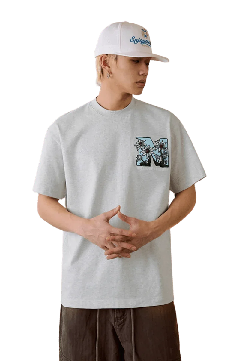MEDM SS25 Big M Daisy Print Tee in Grey with Colorful Front Graphic for Casual Style