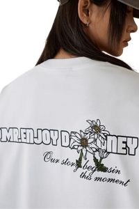 MEDM SS25 Big M Daisy Print Tee with floral design and slogan on the back