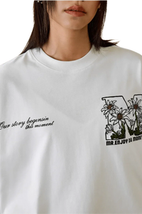 MEDM SS25 Big M Daisy Print Tee featuring floral design and stylish quotes on a white background