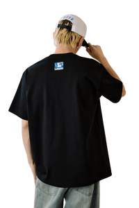 Back view of MEDM SS25 Cat Velcro Embroidery Tee in black worn by a model