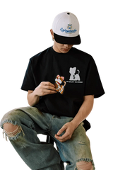 Casual model wearing MEDM SS25 Cat Velcro Embroidery Tee paired with distressed jeans
