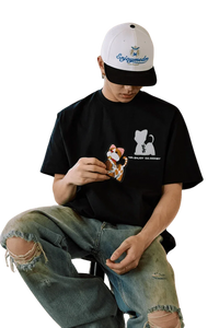 Casual model wearing MEDM SS25 Cat Velcro Embroidery Tee paired with distressed jeans