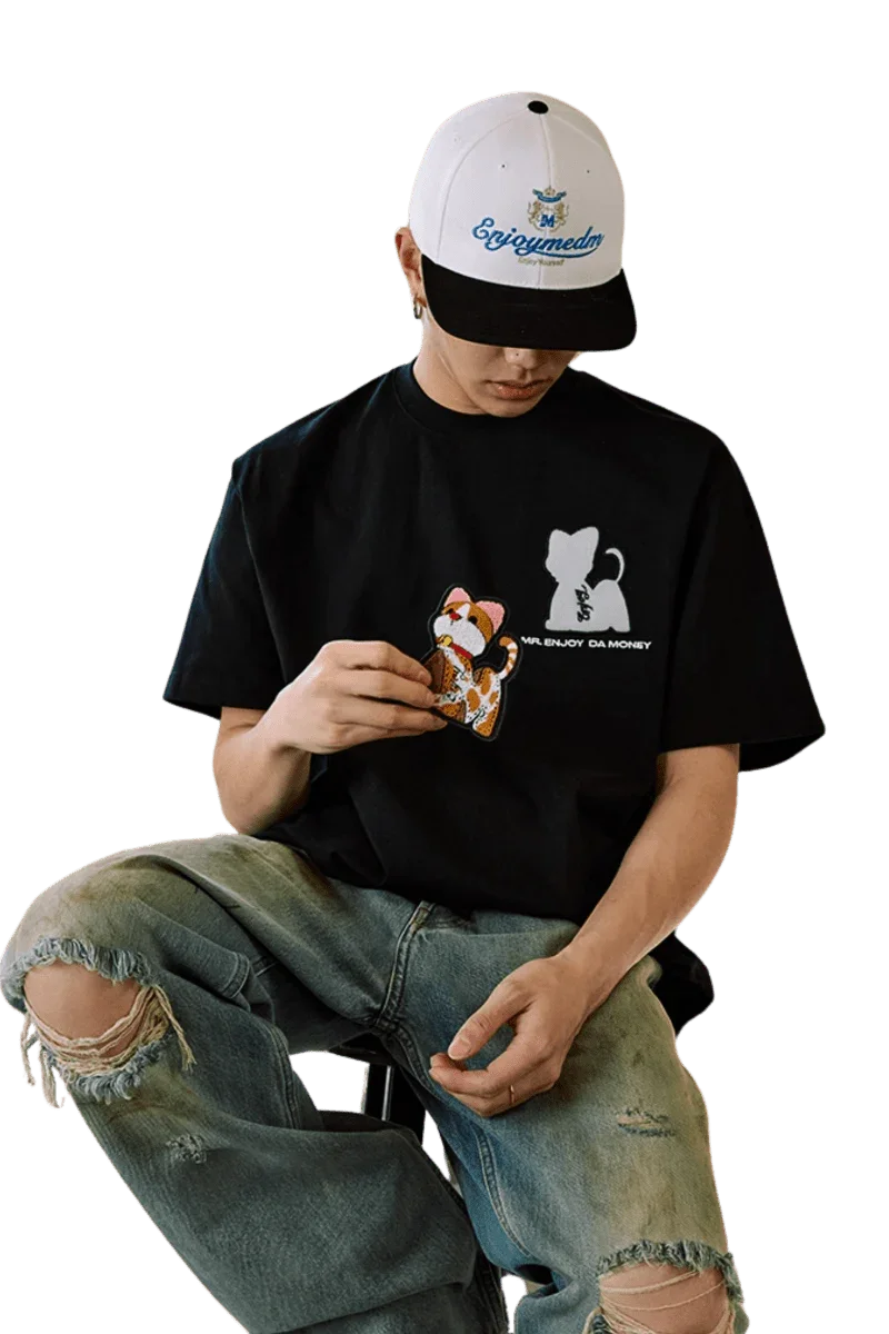 Casual model wearing MEDM SS25 Cat Velcro Embroidery Tee paired with distressed jeans