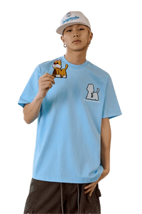 Model wearing MEDM SS25 Cat Velcro Embroidery Tee in light blue with cute animal designs